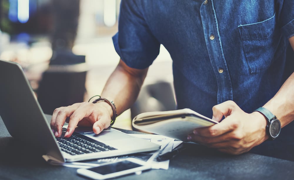 Man working on laptop updating Google My Business account