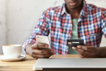 Man making payment online via cell phone